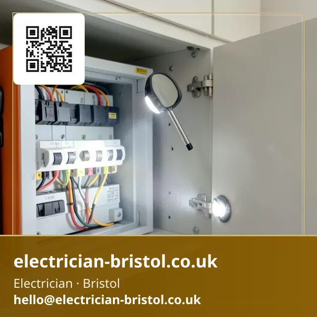 Small inspection mirror on a stick being angled to check behind a consumer unit's circuit breakers with a torch