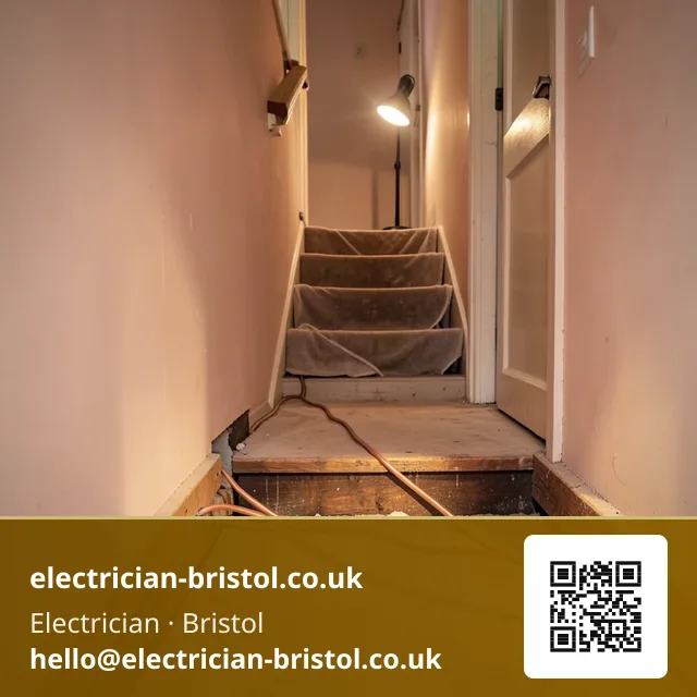 Floorboards lifted along a hallway with new twin-and-earth cable being fed through the joist run beneath