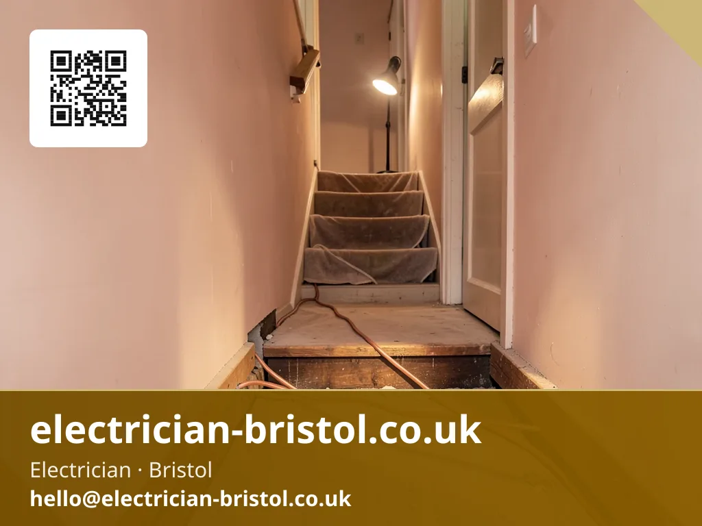 Floorboards lifted along a hallway with new twin-and-earth cable being fed through the joist run beneath