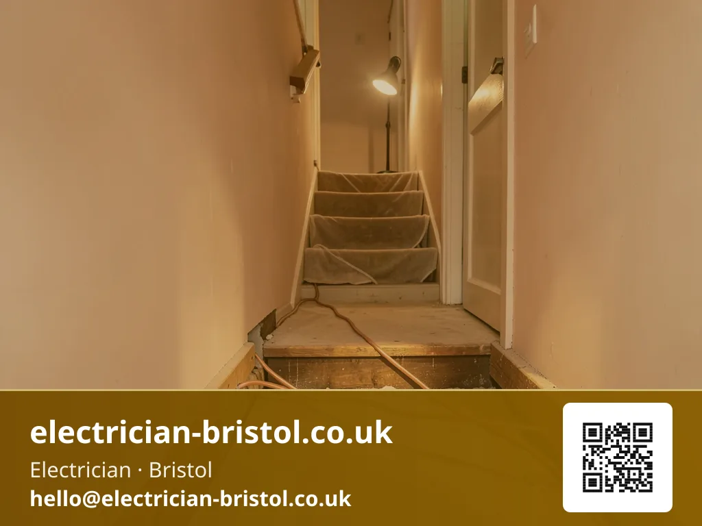 Floorboards lifted along a hallway with new twin-and-earth cable being fed through the joist run beneath