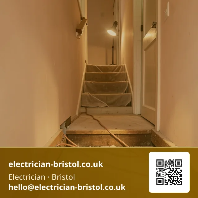 Floorboards lifted along a hallway with new twin-and-earth cable being fed through the joist run beneath