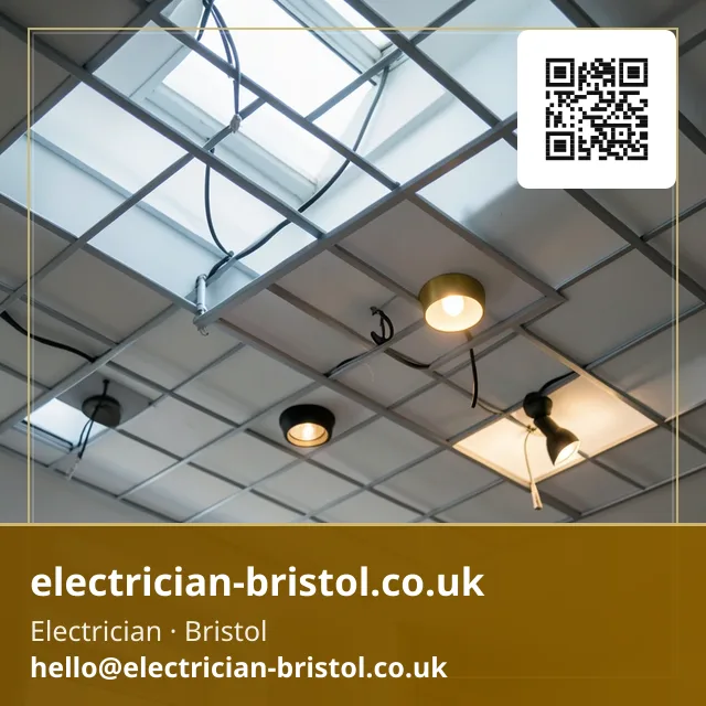 Recessed downlights being fitted into a suspended ceiling grid one bay at a time